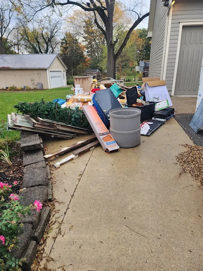 Dumpster being loaded with debris for Roofing Dumpster Rental in West Monroe